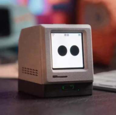 Close-up of Bit Mac AI robot displaying real-time weather and AI chat interface on its OLED screen with tactile blue switch buttons.